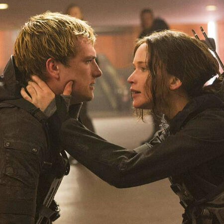Josh Hutcherson as Peeta Mellark and Jennifer Lawrence as Katniss Everdeen in The Hunger Games Mockingjay:Part Two. Katniss is gently holding onto Peeta's face.